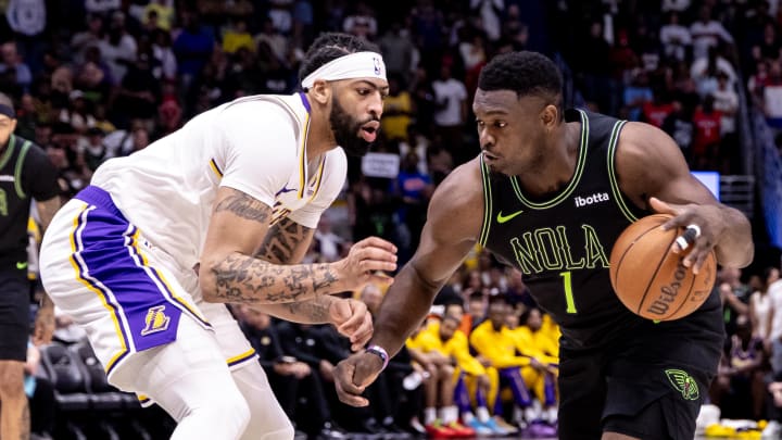 Apr 14, 2024; New Orleans, Louisiana, USA; New Orleans Pelicans forward Zion Williamson (1) dribbles against Los Angeles Lakers forward Anthony Davis (3) during the first half at Smoothie King Center. 