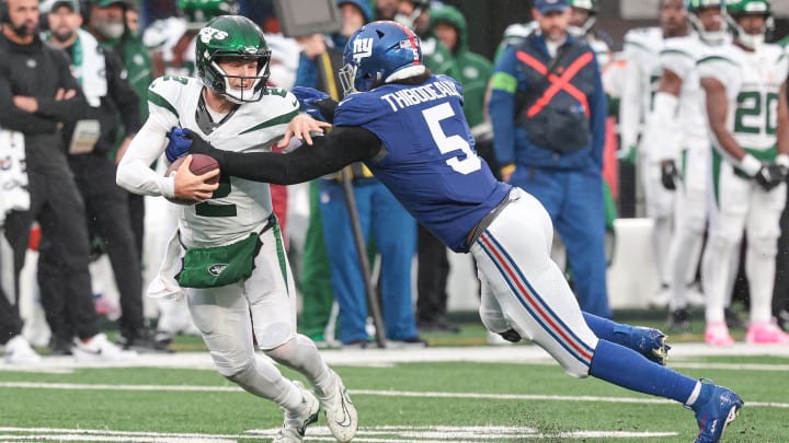 Oct 29, 2023; East Rutherford, New Jersey, USA; New York Giants linebacker Kayvon Thibodeaux (5) sacks New York Jets quarterback Zach Wilson (2) during the second half at MetLife Stadium. Mandatory Credit: Vincent Carchietta-USA TODAY Sports