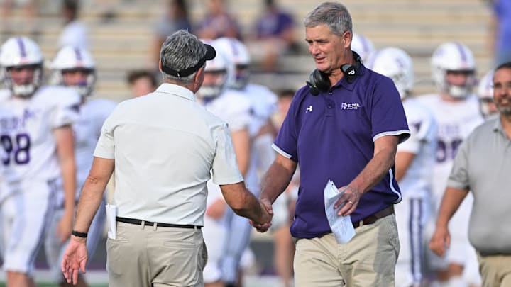 St. Edward head coach Tom Lombardo (left) shakes hands with Elder coach Doug Ramsey after the teams played on September 10, 2022.