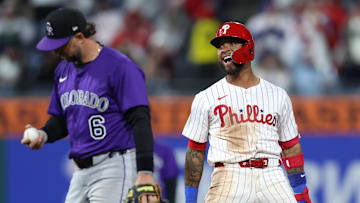 Apr 2, 2025; Philadelphia, Pennsylvania, USA; Philadelphia Phillies shortstop Edmundo Sosa (33) reacts next to Colorado Rockies second base Kyle Farmer (6) after his 2 RBI double during the eighth inning at Citizens Bank Park.