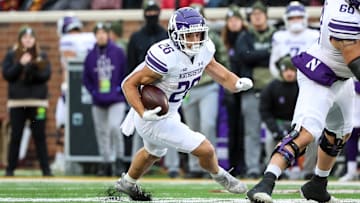 Nov 12, 2022; Minneapolis, Minnesota, USA; Northwestern Wildcats running back Evan Hull (26) runs the ball against the Minnesota Golden Gophers during the first quarter at Huntington Bank Stadium. Mandatory Credit: Matt Krohn-Imagn Images
