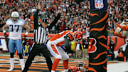 Tennessee Titans safety Calvin Lowry watches as Cincinnati Bengals wide receiver Chad Johnson celebrates an NFL touchdown