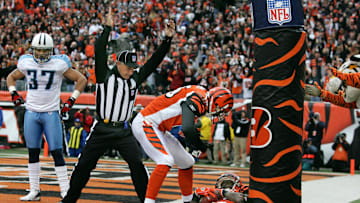 Tennessee Titans safety Calvin Lowry watches as Cincinnati Bengals wide receiver Chad Johnson celebrates an NFL touchdown