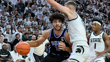 Dec 6, 2025; East Lansing, Michigan, USA;  Duke Blue Devils forward Cameron Boozer (12) advances against Michigan State Spartans center Carson Cooper (15) during the first half at Jack Breslin Student Events Center. Mandatory Credit: Dale Young-Imagn Images