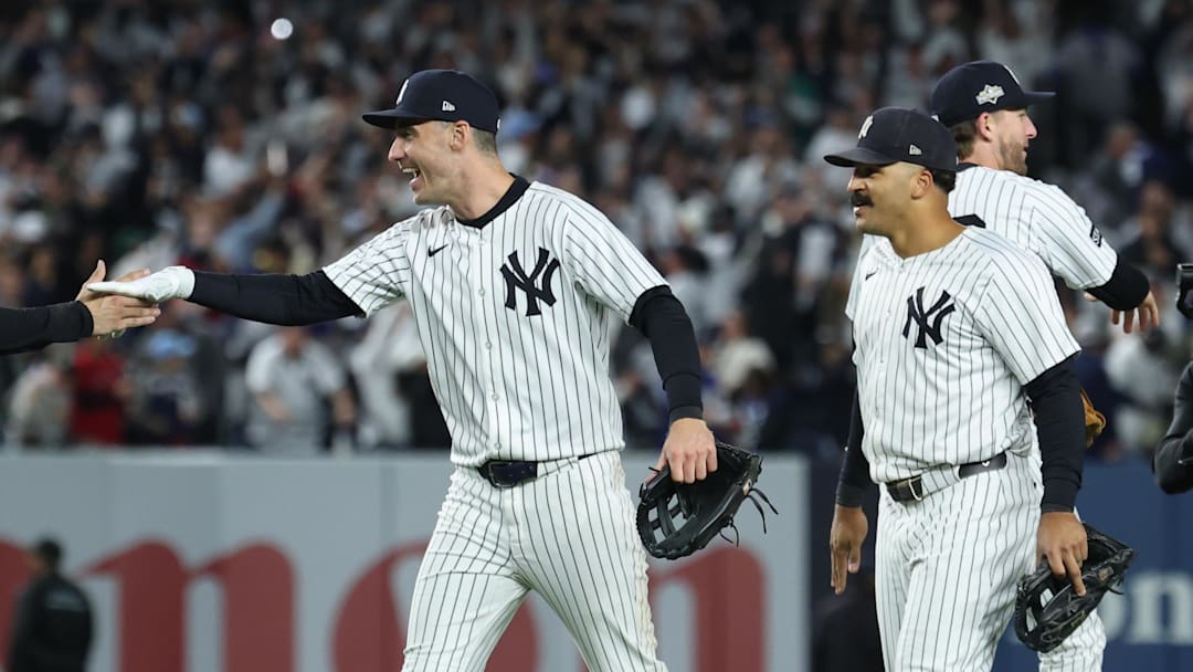 Oct 2, 2025; Bronx, New York, USA; New York Yankees catcher Austin Wells (28) and outfielder Cody Bellinger (35) shake hands following game three of the Wildcard round for the 2025 MLB playoffs against the Boston Red Sox at Yankee Stadium. Mandatory Credit: Vincent Carchietta-Imagn Images
