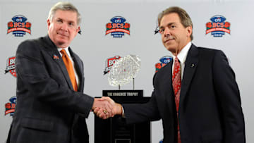 Jan 6, 2010, Newport Beach, CA, USA; Texas Longhorns coach Mack Brown (left) and Alabama Crimson Tide coach Nick Saban pose with the Coaches Trophy at a press conference for the 2010 BCS National Championship.