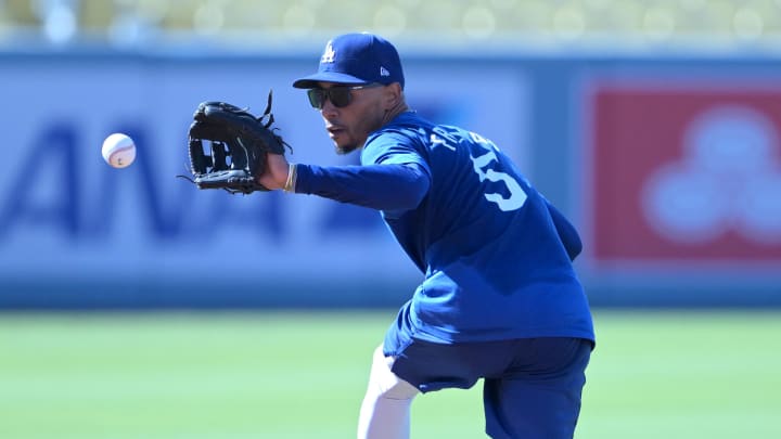 Aug 5, 2024; Los Angeles, California, USA;  Los Angeles Dodgers second baseman Mookie Betts (50) fields ground balls prior to the game against the Philadelphia Phillies at Dodger Stadium. Dodger players wore #MaxStrong shirts during pregame to honor Max, the 3-year old son of first baseman Freddie Freeman (5), who was diagnosed with Guillian-Barre syndrome. Mandatory Credit: Jayne Kamin-Oncea-USA TODAY Sports