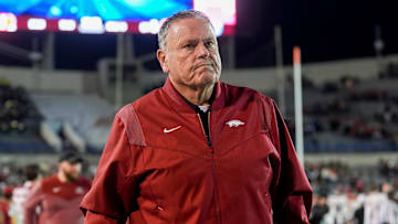 Arkansas' head coach Sam Pittman walks down the sideline assisted by a cane as both teams warm up before the AutoZone Liberty Bowl kicks off between Arkansas and Texas Tech in Memphis, Tenn., on Friday, December 27, 2024.