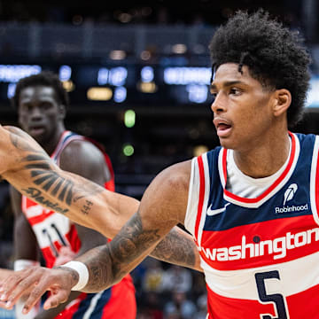 Apr 8, 2025; Indianapolis, Indiana, USA; Washington Wizards guard AJ Johnson (5) dribbles the ball while Indiana Pacers forward Obi Toppin (1) defends in the second half at Gainbridge Fieldhouse. Mandatory Credit: Trevor Ruszkowski-Imagn Images