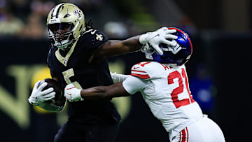 New Orleans Saints running back Kendre Miller (5) stiff-arms New York Giants cornerback Paulson Adebo (21) on Oct. 12, 2025.