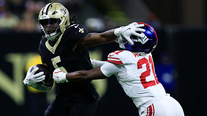 New Orleans Saints running back Kendre Miller (5) stiff-arms New York Giants cornerback Paulson Adebo (21) on Oct. 12, 2025.