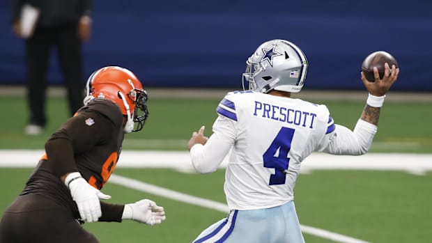 Dallas Cowboys quarterback Dak Prescott (4) drops back to pass against Cleveland Browns defensive end Myles Garrett 