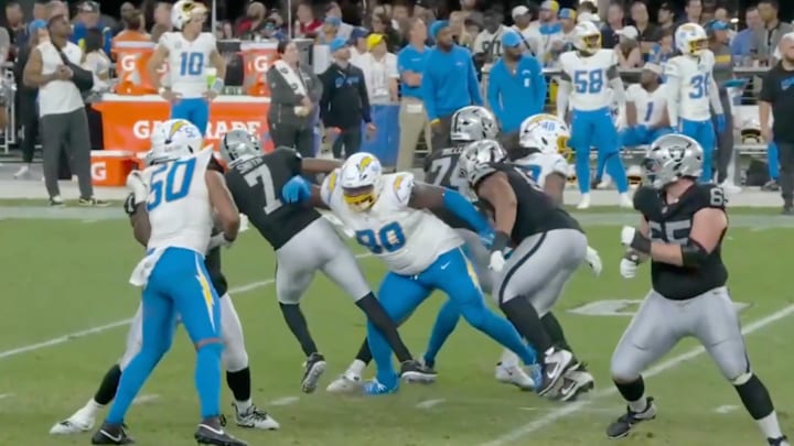 Los Angeles Chargers defensive lineman Teair Tart hits Las Vegas Raiders quarterback Geno Smith late.