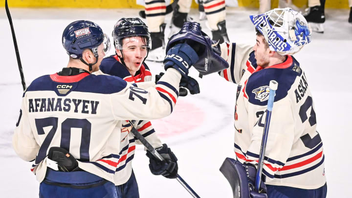 Milwaukee Admirals goaltender Yaroslav Askarov celebrates with left wing Egor Afanasyev and center Fedor Svechkov after a 5-0 victory over the Colorado Eagles on Saturday, January 6, 2024, at UW-Milwaukee Panther Arena in Milwaukee, Wisconsin.