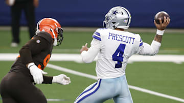 Oct 4, 2020; Arlington, Texas, USA; Dallas Cowboys quarterback Dak Prescott (4) drops back to pass against Cleveland Browns defensive end Myles Garrett (95) in the first quarter at AT&T Stadium. Mandatory Credit: Tim Heitman-USA TODAY Sports