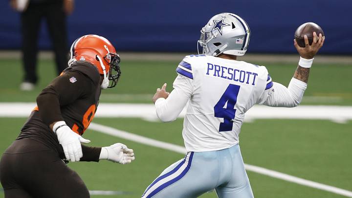 Oct 4, 2020; Arlington, Texas, USA; Dallas Cowboys quarterback Dak Prescott (4) drops back to pass against Cleveland Browns defensive end Myles Garrett (95) in the first quarter at AT&T Stadium. Mandatory Credit: Tim Heitman-USA TODAY Sports