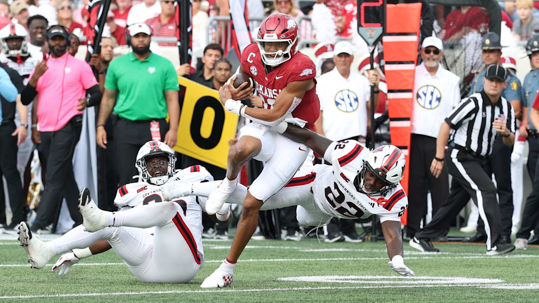 Sep 6, 2025; Little Rock, Arkansas, USA; Arkansas Razorbacks quarterback Taylor Green (10) rushes in the second quarter asArkansas State Red Wolves linebacker Nigel Nelson (22) defends at War Memorial Stadium. Mandatory Credit: Nelson Chenault-Imagn Images