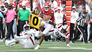 Sep 6, 2025; Little Rock, Arkansas, USA; Arkansas Razorbacks quarterback Taylor Green (10) rushes in the second quarter asArkansas State Red Wolves linebacker Nigel Nelson (22) defends at War Memorial Stadium. Mandatory Credit: Nelson Chenault-Imagn Images