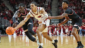 Dec 6, 2025; North Little Rock, Arkansas, USA; Arkansas Razorbacks guard Darius Acuff Jr (5) reaches for the ball between Fresno State Bulldogs guards DJ Stickman (6) and Zaon Collins (10) during the second half at Simmons Bank Arena. Arkansas won 82-58.