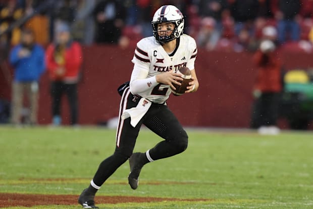 Texas Tech quarterback Behren Morton rolls out to pass against Iowa State.