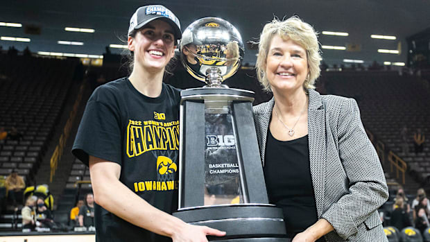 Iowa guard Caitlin Clark, left, poses for a photo with Iowa head coach Lisa Bluder as they hold their Big Ten regular season 