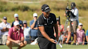Sep 22, 2024; Carrolton, Texas, USA; Patrick Reed of the 4Aces GC flips his putter in the air after missing a putt on the 18th green during the LIV Golf Dallas Team Championship Finals at Maridoe Golf Club. Mandatory Credit: Jim Cowsert-Imagn Images