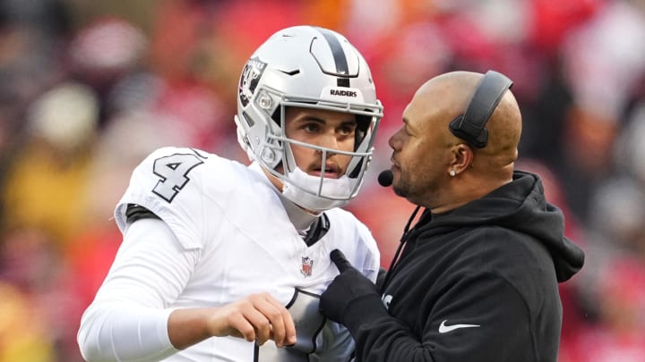 Dec 25, 2023; Kansas City, Missouri, USA; Las Vegas Raiders quarterback Aidan O'Connell (4) talks with head coach Antonio Pierce during the second half against the Las Vegas Raiders at GEHA Field at Arrowhead Stadium. Mandatory Credit: Jay Biggerstaff-USA TODAY Sports