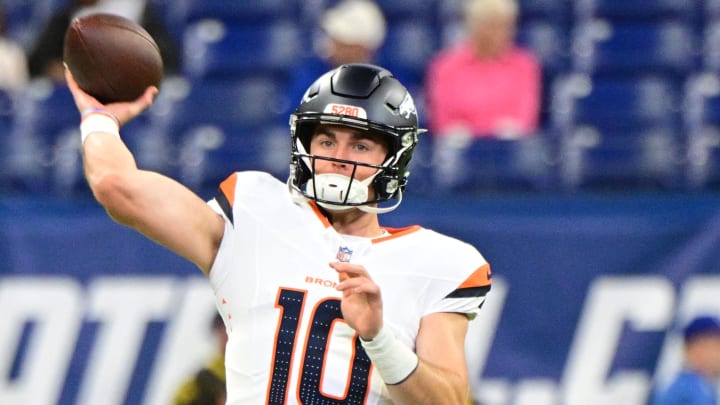 Aug 11, 2024; Indianapolis, Indiana, USA; Denver Broncos quarterback Bo Nix (10) throws a warm up ball before the game against the Indianapolis Colts at Lucas Oil Stadium. 