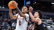 Mar 12, 2025; Indianapolis, IN, USA;  Rutgers Scarlet Knights guard Jamichael Davis (1) shoots the ball while USC Trojans guard Desmond Claude (1) defends in the second half at Gainbridge Fieldhouse. Mandatory Credit: Trevor Ruszkowski-Imagn Images
