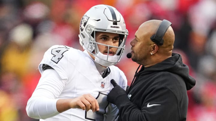 Dec 25, 2023; Kansas City, Missouri, USA; Las Vegas Raiders quarterback Aidan O'Connell (4) talks with head coach Antonio Pierce during the second half against the Las Vegas Raiders at GEHA Field at Arrowhead Stadium. Mandatory Credit: Jay Biggerstaff-USA TODAY Sports