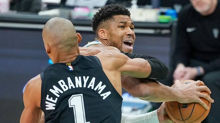 Jan 15, 2026; San Antonio, Texas, USA;  San Antonio Spurs forward/center Victor Wembanyama (1) fouls Milwaukee Bucks forward Giannis Antetokounmpo (34) in the first half at Frost Bank Center. Mandatory Credit: Daniel Dunn-Imagn Images