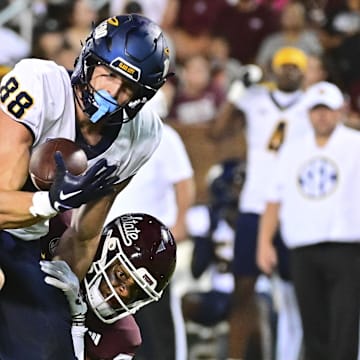 Toledo Rockets tight end Anthony Torres (88) makes a reception as he is hit by Mississippi State Bulldogs safety Isaac Smith (2) during the second quarter at Davis Wade Stadium at Scott Field.