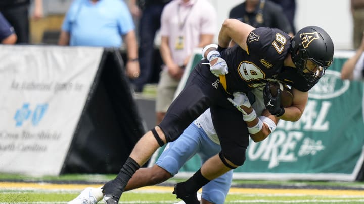 Sep 3, 2022; Boone, North Carolina, USA; Appalachian State Mountaineers tight end Eli Wilson (87) a North Carolina defender during the first quarter at Kidd Brewer Stadium. Mandatory Credit: Jim Dedmon-USA TODAY Sports