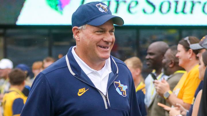 Sep 27, 2025; Morgantown, West Virginia, USA; West Virginia Mountaineers head coach Rich Rodriguez walks on the field and greets fans before their game against the Utah Utes at Milan Puskar Stadium. Mandatory Credit: Ben Queen-Imagn Images