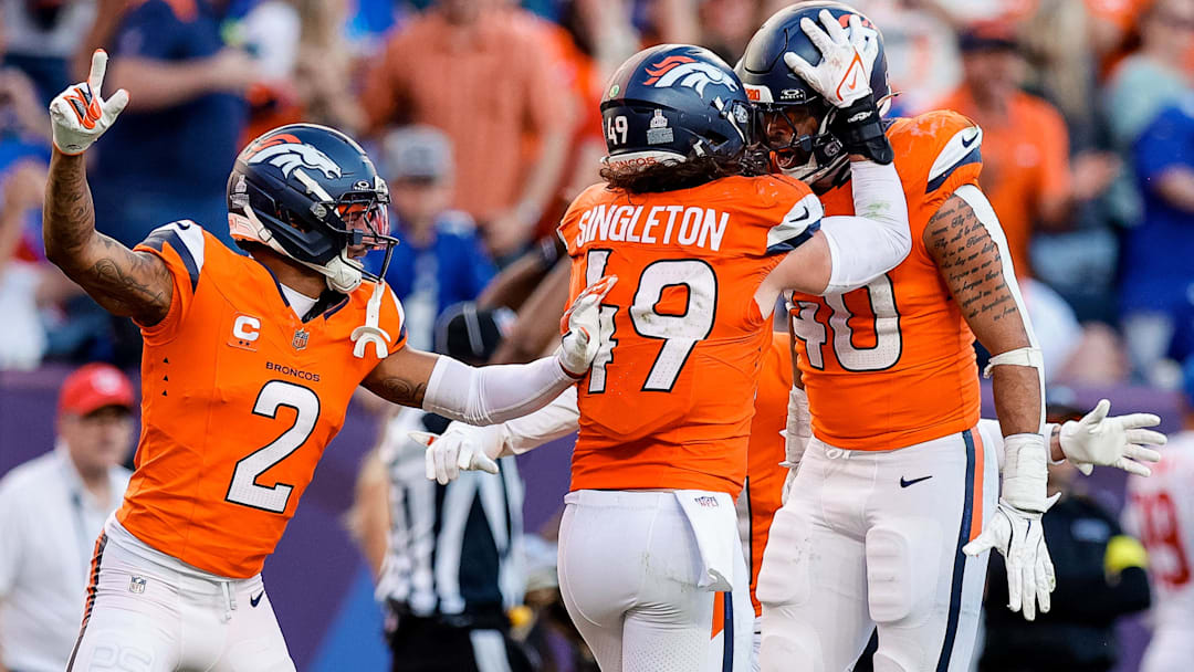 Oct 19, 2025; Denver, Colorado, USA; Denver Broncos linebacker Justin Strnad (40) celebrates his interception with linebacker Alex Singleton (49) and cornerback Pat Surtain II (2) in the fourth quarter against the New York Giants at Empower Field at Mile High. 