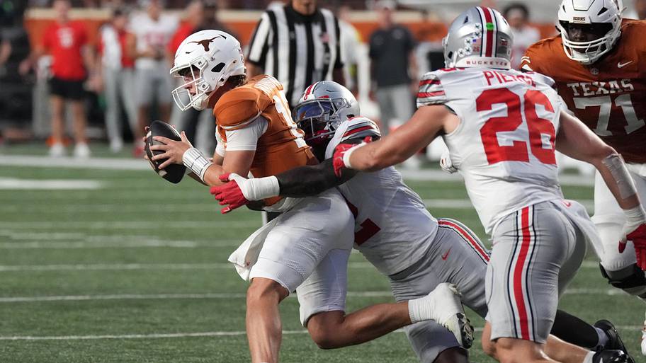 Ohio State Buckeyes defensive end Kenyatta Jackson Jr. tackles Texas Longhorns quarterback Arch Manning.