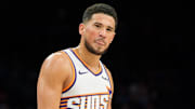 Phoenix Suns guard Devin Booker (1) reacts and sticks out his tung after a foul is called against the Suns during the second half of a game against the Atlanta Hawks at Mortgage Matchup Center. Mandatory Credit: Allan Henry-Imagn Images