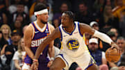 Dec 12, 2023; Phoenix, Arizona, USA; Golden State Warriors forward Jonathan Kuminga (00) against Phoenix Suns guard Devin Booker (1) at Footprint Center. Mandatory Credit: Mark J. Rebilas-Imagn Images