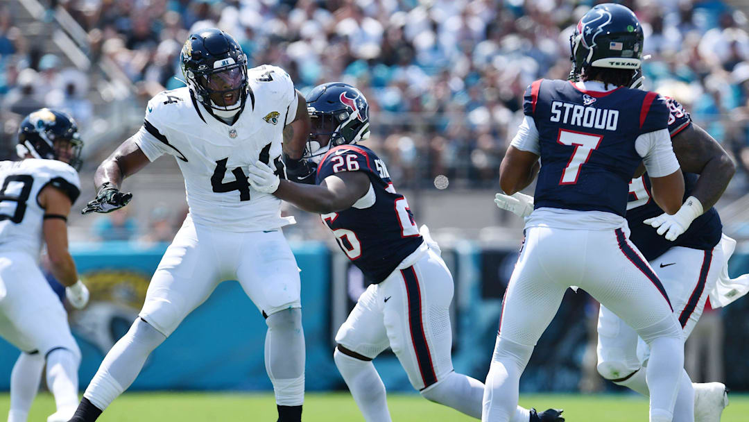 Houston Texans running back Devin Singletary (26) tries to hold back Jacksonville Jaguars linebacker Travon Walker (44) as he tries to get to Texans quarterback C.J. Stroud (7) during first quarter action. The Jacksonville Jaguars hosted the Houston Texans at EverBank Stadium in Jacksonville, Fla. Sunday, September 24, 2023. The Jaguars trailed 17 to 0 at the end of the first half. [Bob Self/Florida Times-Union]