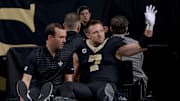 Dec 1, 2024; New Orleans, Louisiana, USA; New Orleans Saints tight end Taysom Hill (7) leaves the field after an injury against the Los Angeles Rams during the second half at Caesars Superdome. Mandatory Credit: Matthew Hinton-Imagn Images