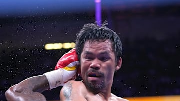 Aug 21, 2021; Las Vegas, Nevada; Manny Pacquiao (top) fights Yordenis Ugas in a world welterweight championship bout at T-Mobile Arena. Mandatory Credit: Stephen R. Sylvanie-Imagn Images