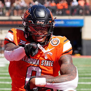 Oklahoma State's Ollie Gordon II (0) celebrates a 2-point conversion front of Jaylon Braxton (11) in double overtime of the college football game between the Oklahoma State Cowboys and the Arkansas Razorbacks at Boone Pickens Stadium in Stillwater, Okla.,, 