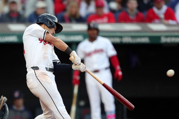 Steven Kwan swings at a pitch 