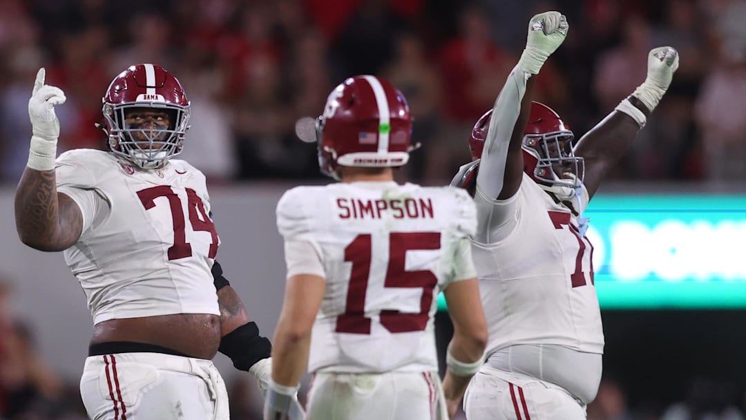 Alabama Crimson Tide offensive lineman Kadyn Proctor (74) celebrates with quarterback Ty Simpson (15)