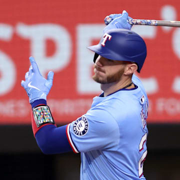 Texas Rangers catcher Jonah Heim (28) singles in a run during the third inning against the Atlanta Braves at Globe Life Field. 