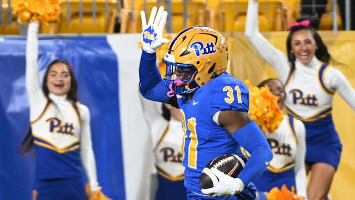 Oct 24, 2024; Pittsburgh, Pennsylvania, USA; Pittsburgh Panthers linebacker Rasheem Biles (31) returns an interception for a touchdown against the Syracuse Orange during the first quarter at Acrisure Stadium. Mandatory Credit: Barry Reeger-Imagn Images Oct 24, 2024; Pittsburgh, Pennsylvania, USA; Pittsburgh Panthers linebacker Rasheem Biles (31) returns an interception for a touchdown against the Syracuse Orange during the first quarter at Acrisure Stadium. Mandatory Credit: Barry Reeger-Imagn Images