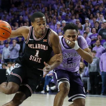 Jan 20, 2024; Manhattan, Kansas, USA; Oklahoma State Cowboys guard Bryce Thompson (1) dibbles by Kansas State Wildcats guard Tylor Perry (2) during the second half at Bramlage Coliseum. Mandatory Credit: Scott Sewell-USA TODAY Sports