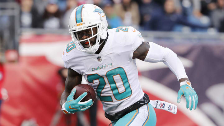 Miami Dolphins free safety Reshad Jones (20) runs the ball back for a touchdown after recovering a fumble against the New England Patriots during the second quarter at Gillette Stadium in 2017.