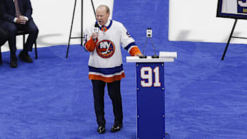 Feb 29, 2020; Uniondale, New York, USA;  Former New York Islanders player Butch Goring addresses the fans during the ceremony retiring his number 91 jersey prior to the game against the Boston Bruins at Nassau Veterans Memorial Coliseum. Mandatory Credit: Andy Marlin-Imagn Images