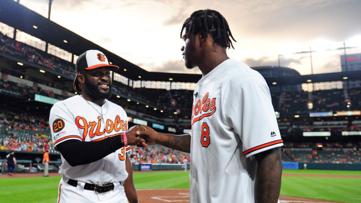 Jul 17, 2019; Baltimore, MD, USA; Baltimore Orioles outfielder Dwight Smith Jr. (35) shakes hands with Baltimore Ravens quarterback Lamar Jackson (8) prior to the game against the Washington Nationals at Oriole Park at Camden Yards. Mandatory Credit: Evan Habeeb-USA TODAY Sports